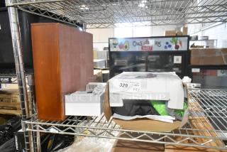 Three brand new items including an inflatable witch decoration and a wooden unit on a metal shelf, with minor box damage.