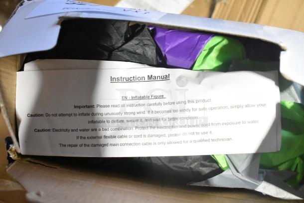 Box containing a new inflatable witch decoration with instruction manual. Note mentions handling precautions.