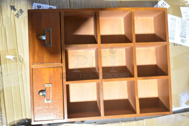 Wooden storage unit with two drawers and nine compartments. Brand new, some scratch and dent marks visible.