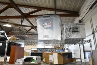 Six items including a diamond plate tool box, clear poly bin labeled "bella," and wire baskets on metal shelves.