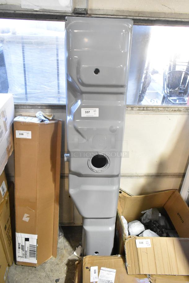 Gray metal unit with two large openings, used condition. Label shows "337 QTY 1." Placed among cardboard boxes.