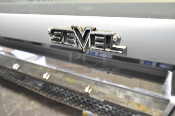 Sevel Metal Commercial Gelato Case with stainless steel drop-in bins, featuring a Sevel brand logo.