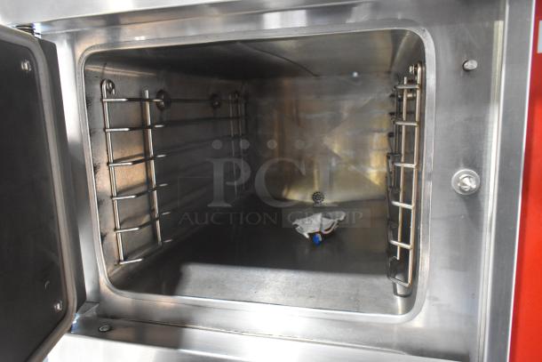 Vulcan VSX24G stainless steel commercial steam cabinet interior. Natural gas-powered, 200,000 BTU, 2 deck, clean condition.