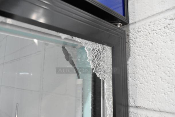 Broken glass detail on new Avantco 178GDC40HCB 2-door reach-in cooler merchandiser. Metal frame, poly-coated racks, on casters.