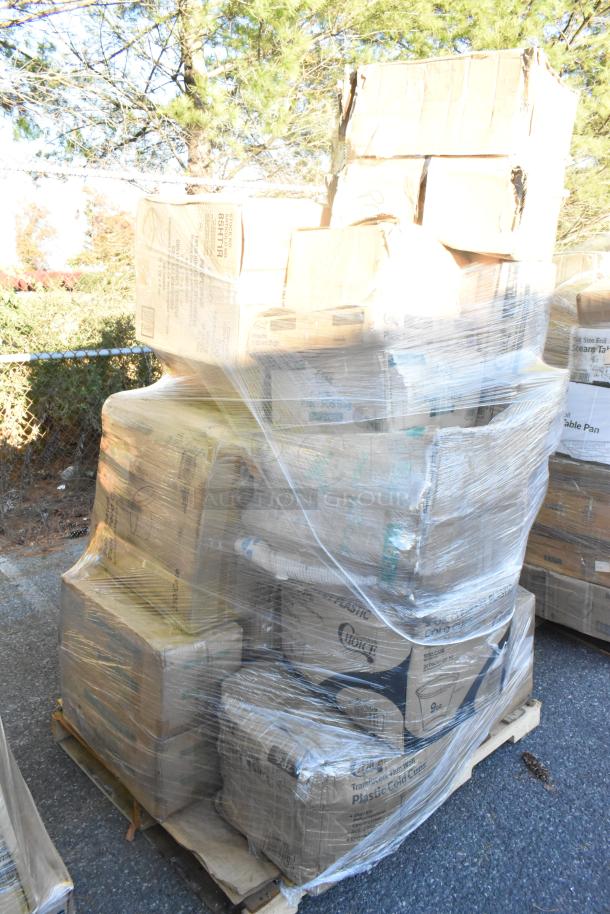 Pallet of assorted scratch and dent items wrapped in plastic, including cold cups, paper towels, and take-out containers.