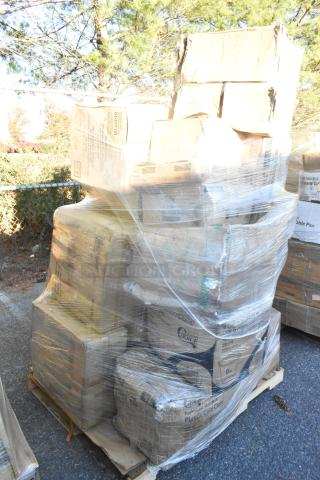 Pallet of assorted scratch and dent items wrapped in plastic, including cold cups, paper towels, and take-out containers.