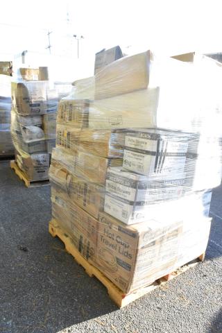 Pallet of various boxed items including straws and squat cups, wrapped in plastic. Packages show some wear and markings.