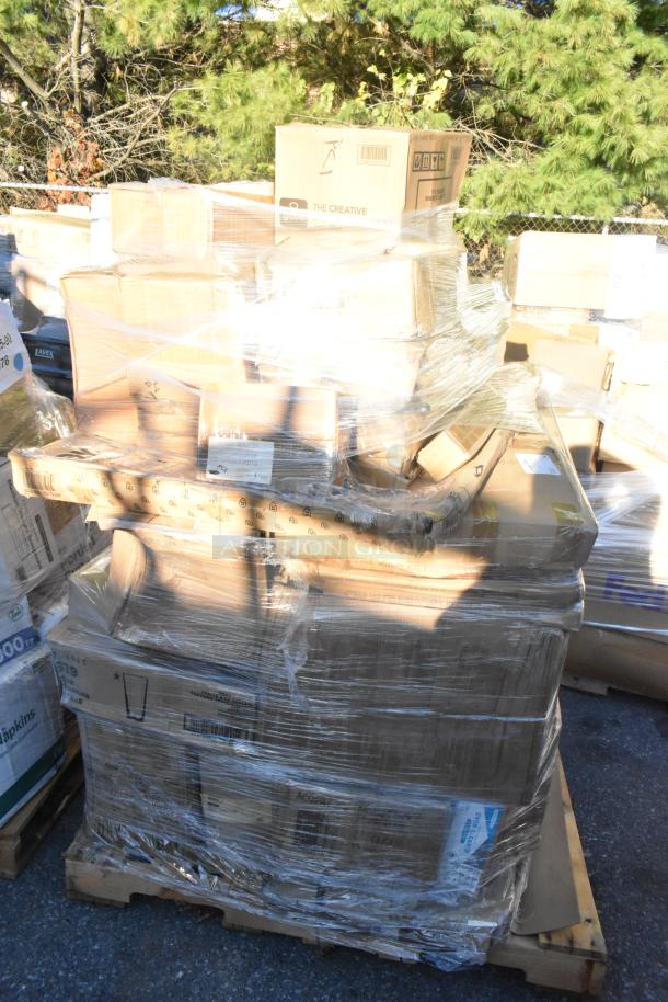 Pallet of wrapped boxes labeled "The Creative" containing various new scratch and dent items like glasses, tumblers, and plates.