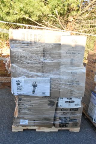 Pallet of assorted new items including cup carriers, cake circles, salad bowls, and plastic plates, boxed and wrapped.