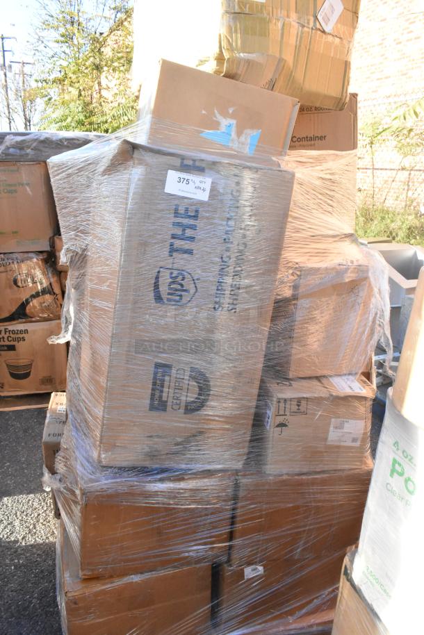 Stack of new boxed items wrapped in plastic, including glasses and steam pans. Visible labels show shipping and packaging details.