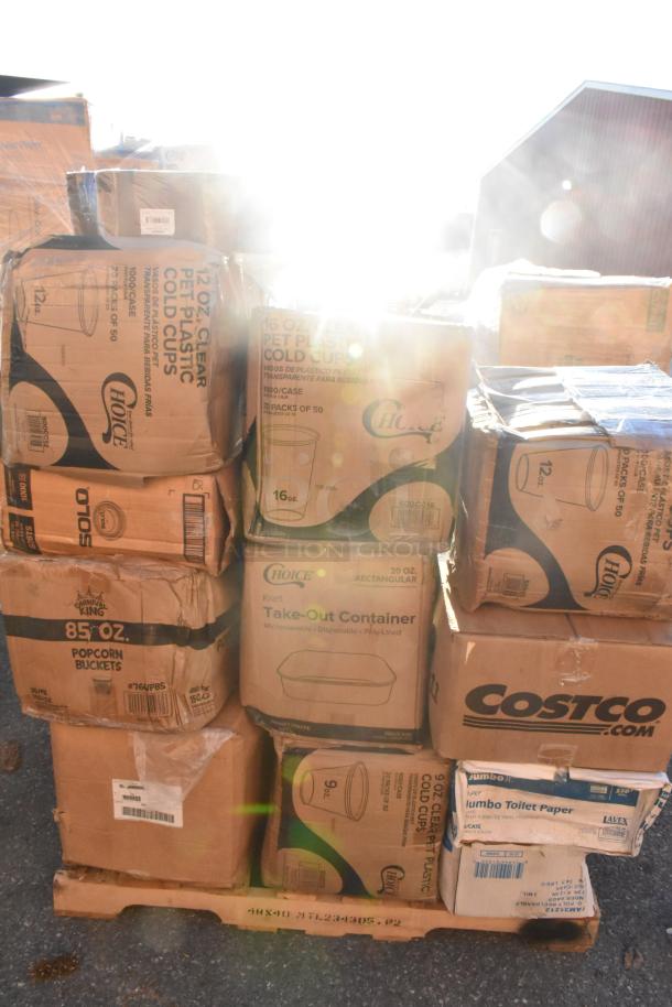 Boxes of new scratch and dent items including cold cups, popcorn buckets, mop heads, and paper towels on a pallet.