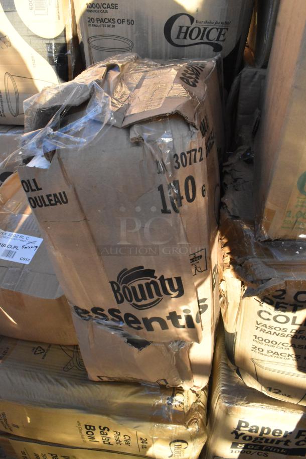 Stack of boxes with brands Bounty, Choice. Boxes are dented and scratched, containing cold cups, popcorn buckets, paper towels.
