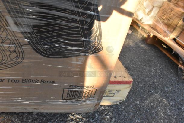 Pallet with boxed scratch and dent items, including lids, containers, and food trays. Box labeled "Clear Top Black Base #500T0963."