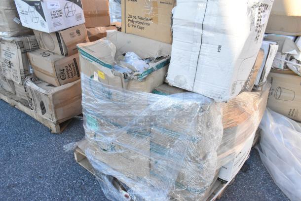 16 brand new scratch and dent items including plates, cups, forks, and tasting spoons on a pallet, boxed and wrapped.