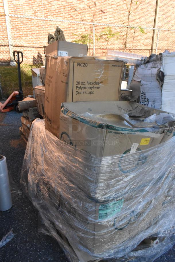 Pallet of 16 brand new scratch and dent items, including plates, tasting spoons, and Nexclear drink cups, wrapped in plastic.