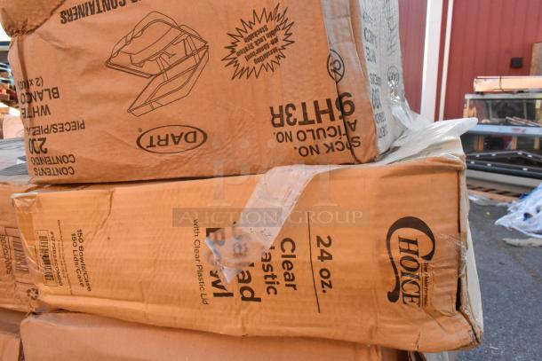 Boxes of scratch and dent items stacked outdoors, featuring Dart and Choice brand labels, indicating paper plate and dispenser contents.