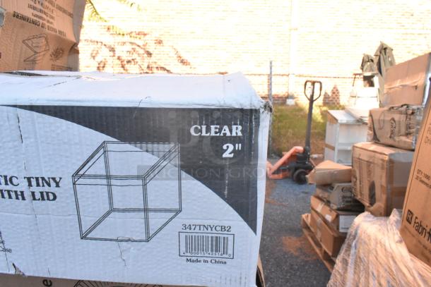 Cardboard box labeled "347TNYCB2" containing clear plastic tiny cube with lid, marked "CLEAR 2", new condition.