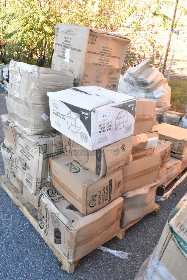 Pallet of 23 new scratch and dent boxes with various items including dispensers, mini cubes, and paper plates. Boxes labeled.