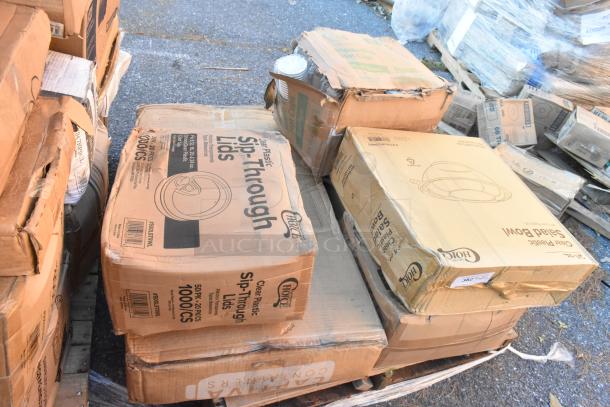 Boxes of brand new scratch and dent items, including salad bowls and sip-through cup lids, visible on a pallet.