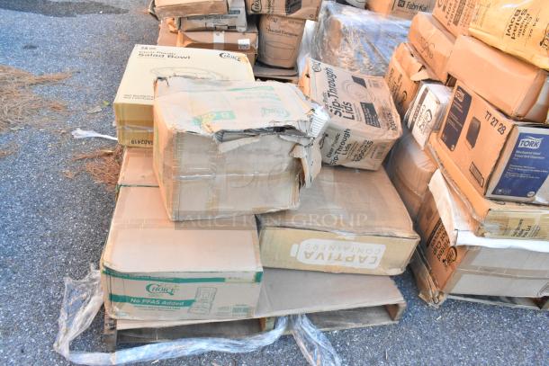 Boxes of brand new scratch and dent items including salad bowls and hot cups on pallets, varied brands visible.