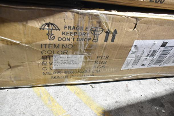 Two brand new scratch and dent items in a cardboard box. Labels show item numbers RVG1915-250306-0006-156 and P02311131100, marked fragile, with dimensions 85x35x21cm, made in China. Box shows slight wear.