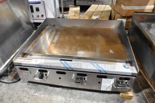 Brand new Wolf AGM36-101 stainless steel commercial flat top griddle, natural gas, 81,000 BTU, with visible manufacturer label.