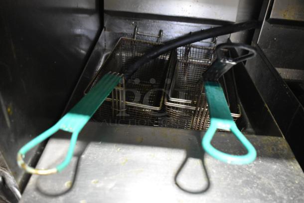 Giles GVH-C ventless recirculating hood system with two stainless steel commercial fryers, green fryer handles visible.