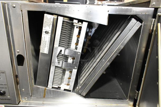 Giles GVH-C stainless steel ventless hood system, electrostatic air cleaner visible. Clean condition, labels indicate airflow direction.