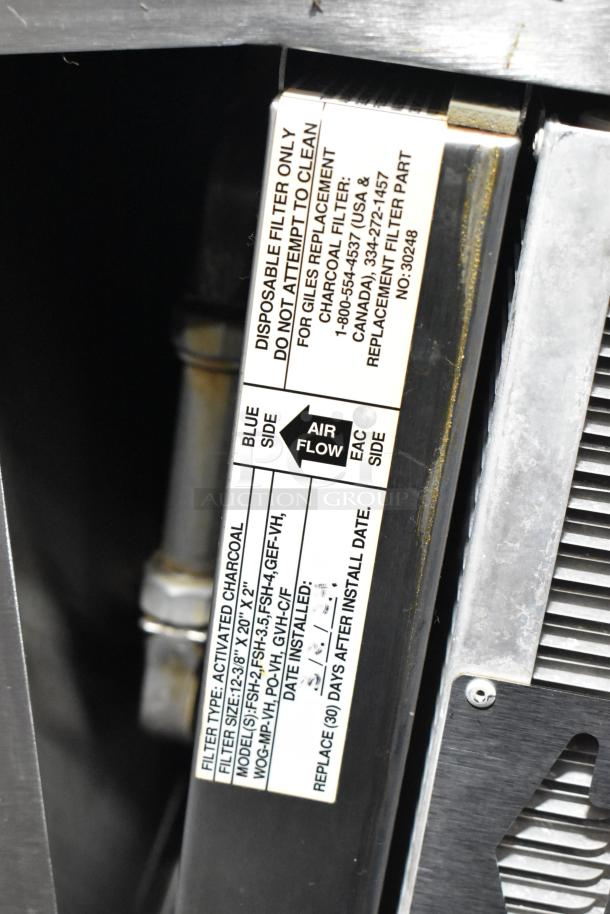 Giles GVH-C ventless hood filter with label showing airflow direction, filter type, and replacement details.