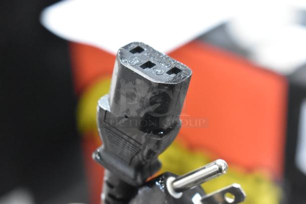 Close-up of a power plug for a Vacmaster VP215 chamber vacuum sealer. Plug shows standard prongs and black color.