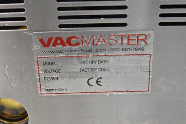 Vacmaster VP215 stainless steel chamber vacuum sealer, model VP215, shows label with 120V, 1-phase, 0.4KW. Factory date 03/2025. Made in China.