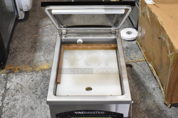 Vacmaster VP215 stainless steel chamber vacuum sealer, commercial countertop model. Open lid, clean condition. 120 volts, 1 phase.