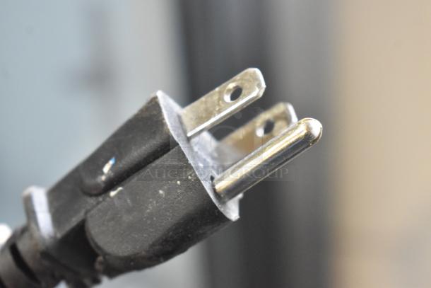 Close-up of a standard 115-volt, 1-phase power plug suitable for a Hisense FL-35WC1H cooler.