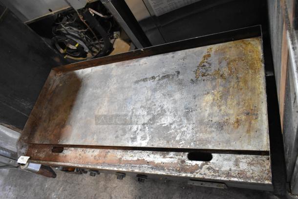 Garland stainless steel commercial electric griddle, countertop model, 240 volts, showing signs of wear, with control knobs.