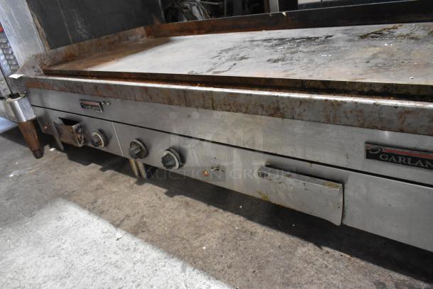 Garland Stainless Steel Commercial Flat Top Griddle, electric-powered, 240 volts, used condition, visible wear on surface.