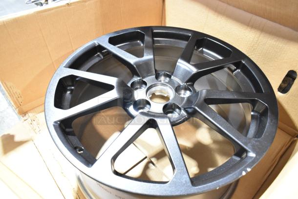 Brand new GM 19303155 rim in box, sleek black finish, 5-lug pattern, pristine condition, ideal for cars needing stylish upgrades.