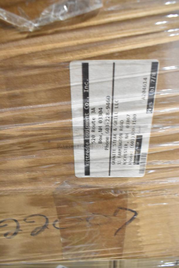 Cardboard boxes with handling stickers, marked "Kittredge Equipment Co., Inc." containing Carlisle Bistro tumblers and ashtrays.