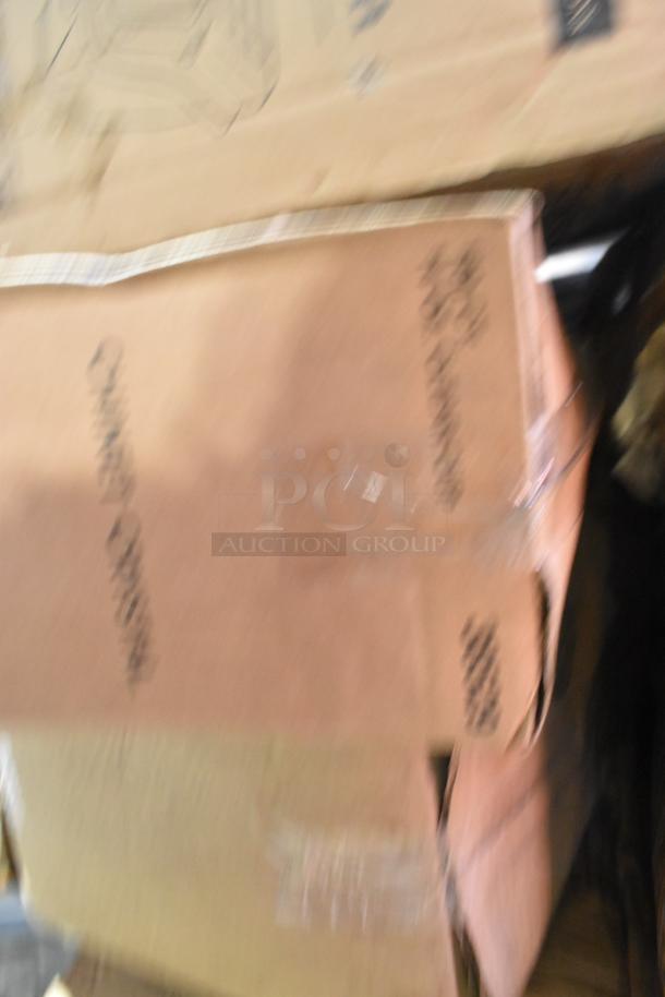 Blurred image of stacked cardboard boxes. Labels and markings are indistinct. Boxes are part of an auction for new scratch and dent items.