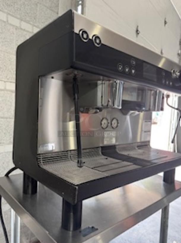 WMF Espresso Model 30.5500 machine with dual grinders, two steam wands, and cup storage. Tested, 208V, 30 Amps, working condition.