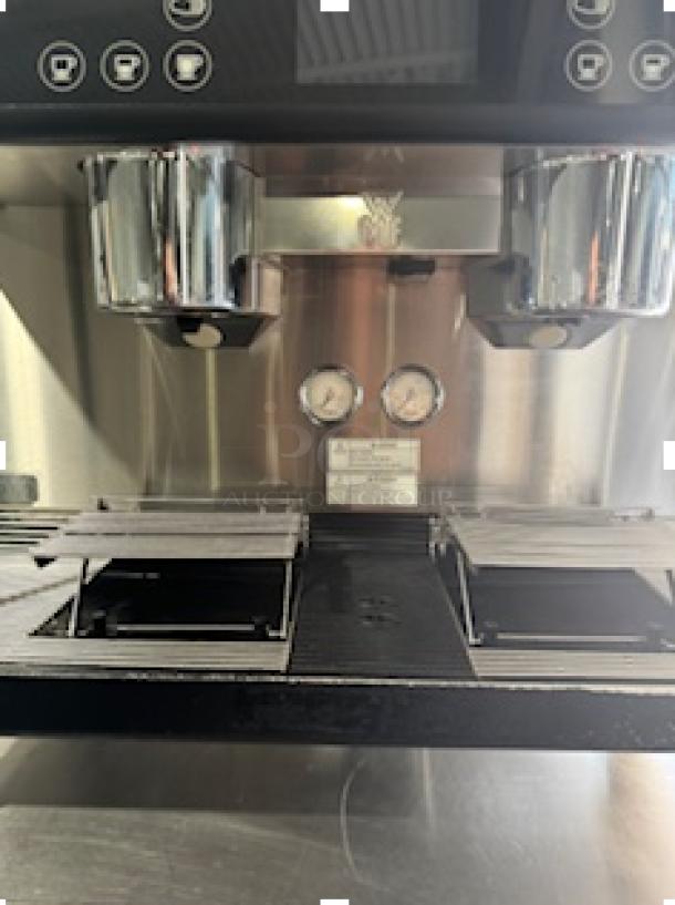 WMF Espresso Model 30.5500 with dual grinders and steam wands. Features hot water outlet, heatable cup storage. Tested and working.