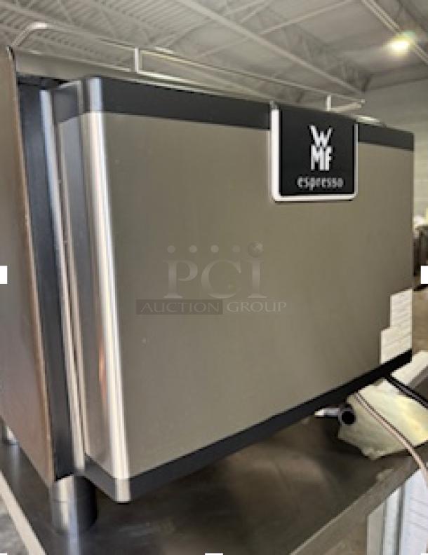 WMF Espresso Model 30.5500 machine with cup storage and dual grinders. Tested, working condition. Labels indicate model.
