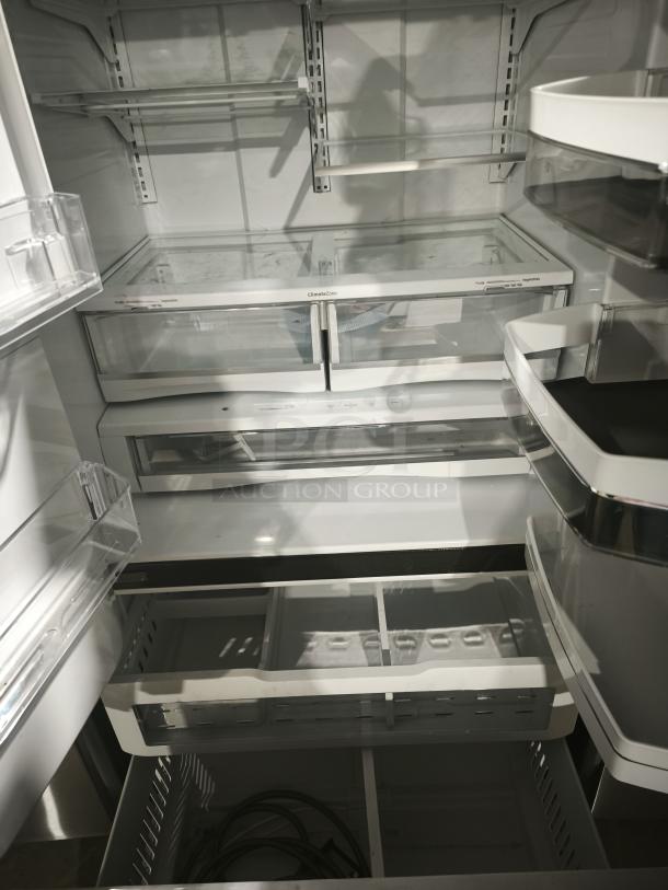 GE 27.7 Cu. Ft. French-Door Refrigerator, stainless steel, fingerprint-resistant, model GFE28GYNFS, interior shelves and bins visible.