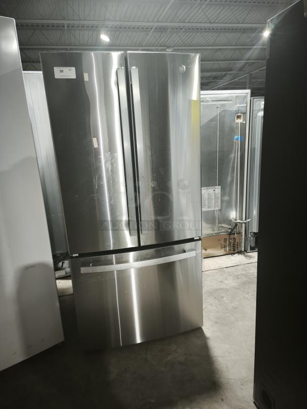 GE 27.7 Cu. Ft. fingerprint-resistant French-door refrigerator in stainless steel, Model GFE28GYNFS. Appears in good condition.