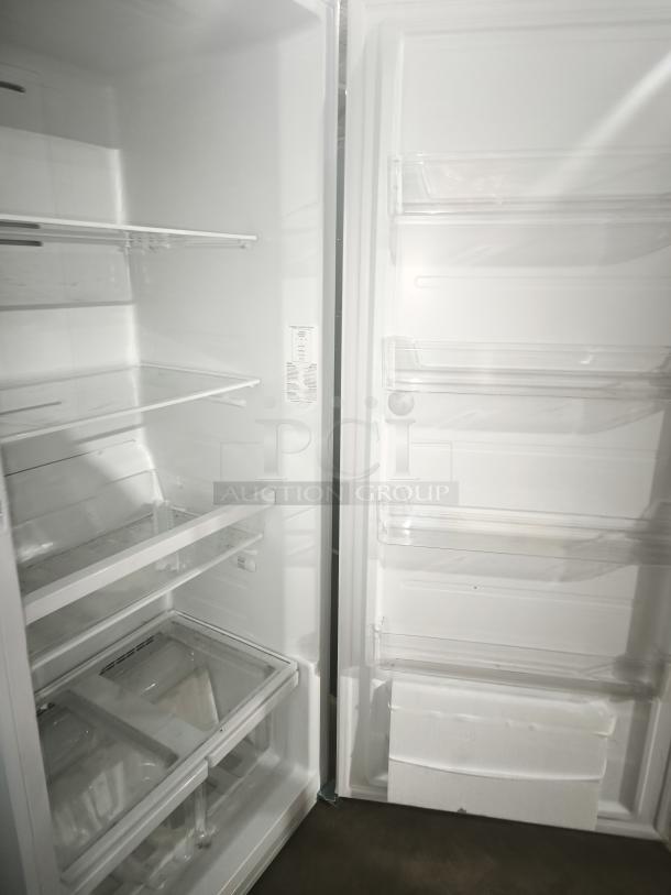 GE 21.3 Cu. Ft. Frost-Free Upright Freezer, model GFE28GYNFS, like new, garage ready, adjustable shelves, interior label visible.