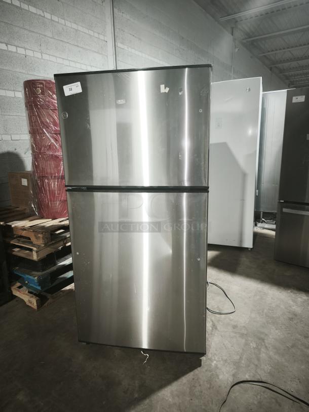 GE ENERGY STAR 21.1 cu. ft. top-freezer refrigerator, model GIE21GSHSS, stainless steel finish, visible wear.