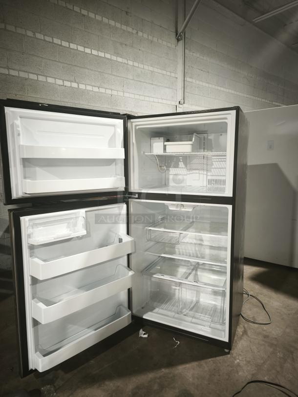 GE ENERGY STAR® 21.1 cu. ft. top-freezer refrigerator, model GIE21GSHSS, open doors, spacious interior, pristine condition.