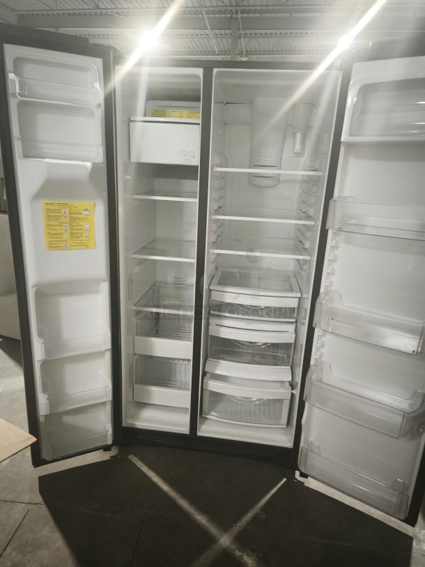 GE 25.1 cu. ft. fingerprint-resistant side-by-side refrigerator, model GSS25IYNFS, open doors showing shelves and bins.