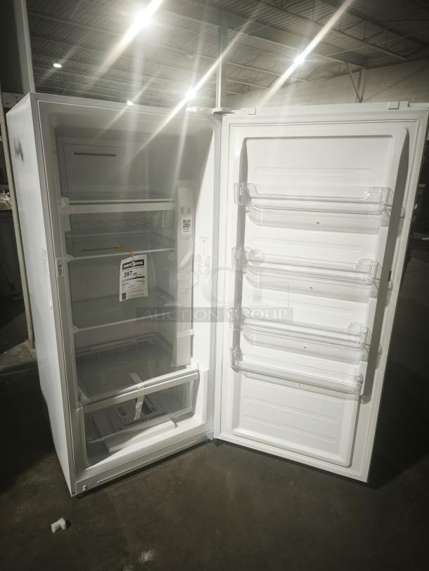GE 14.1 Cu. Ft. Frost-Free Garage-Ready Upright Freezer, model FUF14DLRWW, open door showing shelves and tags.
