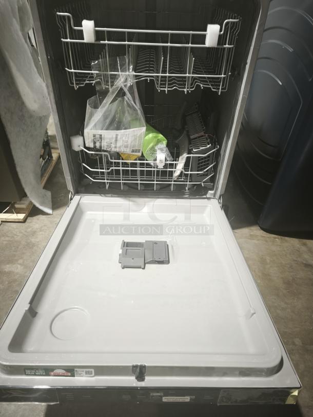 BRAND NEW GE Energy Star dishwasher model GDT665SSNSS, top control, plastic interior, with sanitize cycle and Dry Boost™, showing open interior and protective packaging.