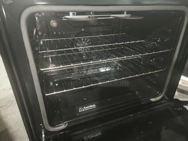 GE 30-inch electric convection range, model GRF600AVSS, new with scratches, WiFi features, interior view showing racks.